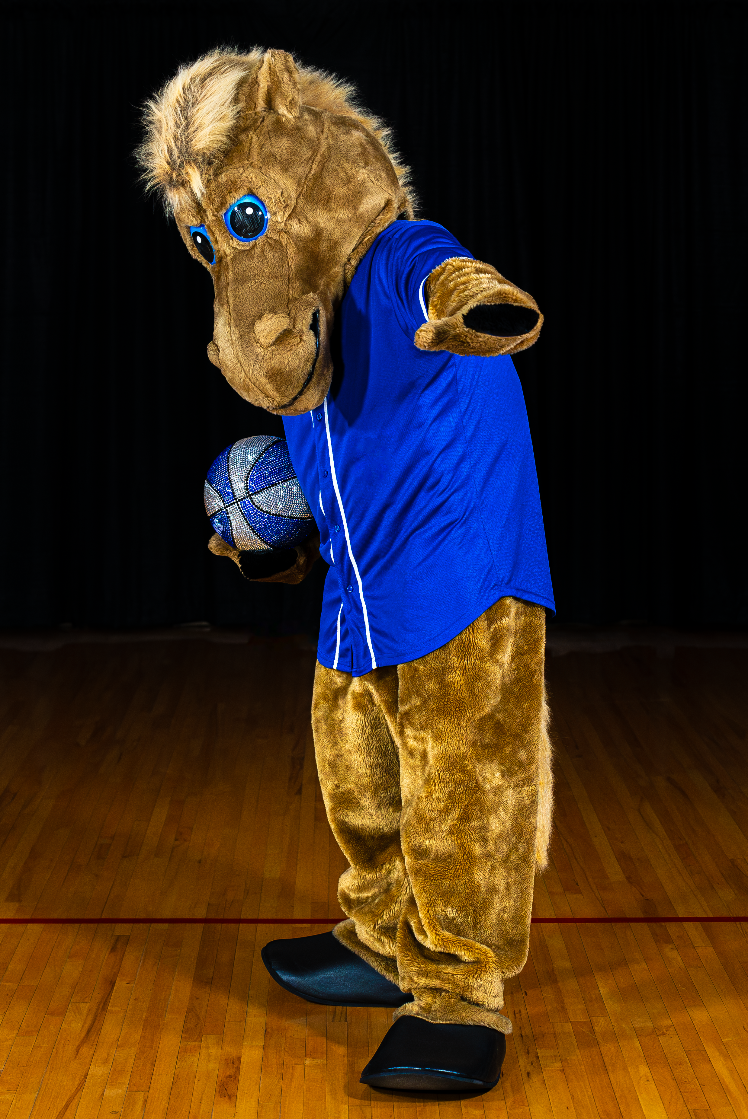 Billie the horse mascot with a basketball ball