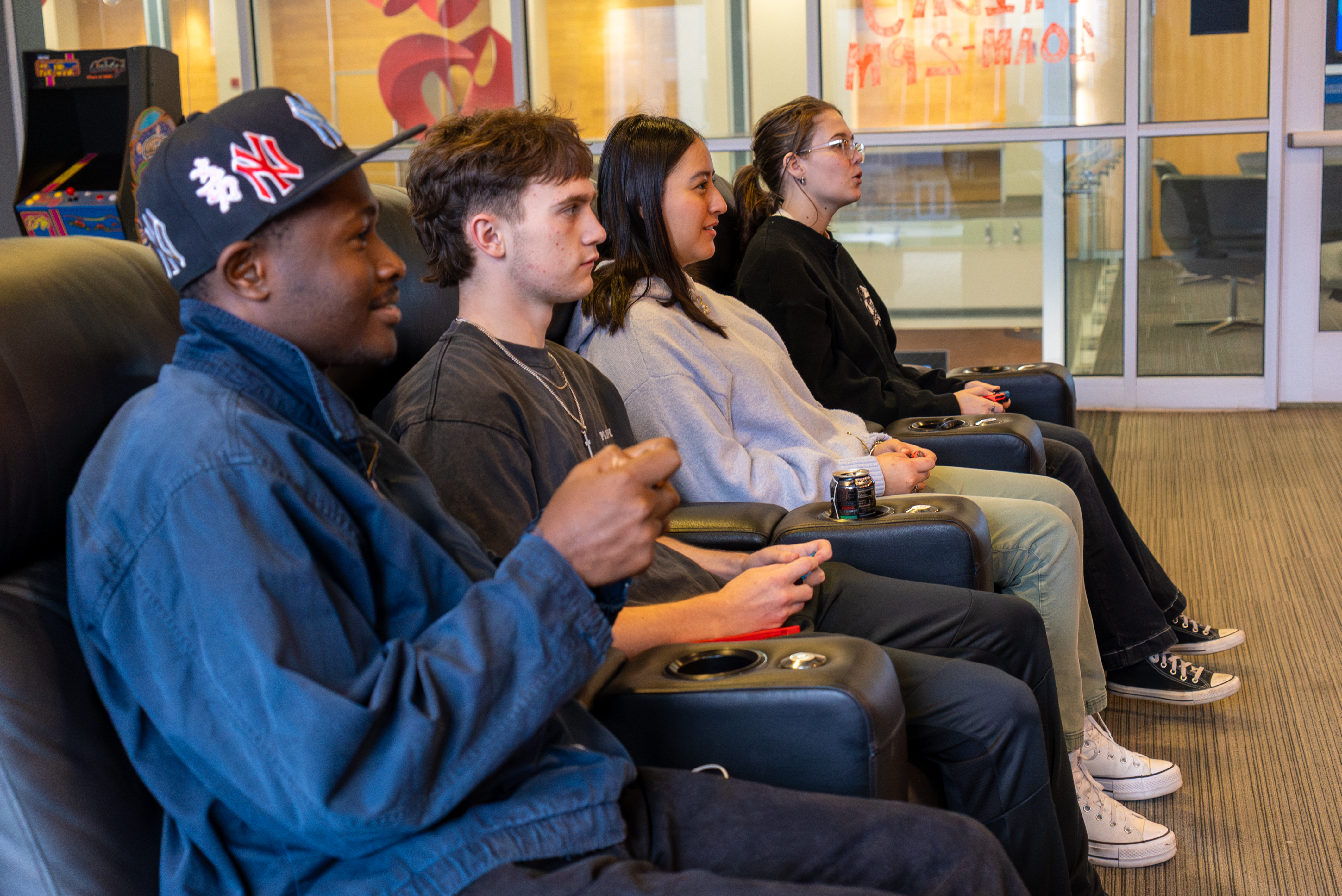 A group of students enjoying playing a video game together.