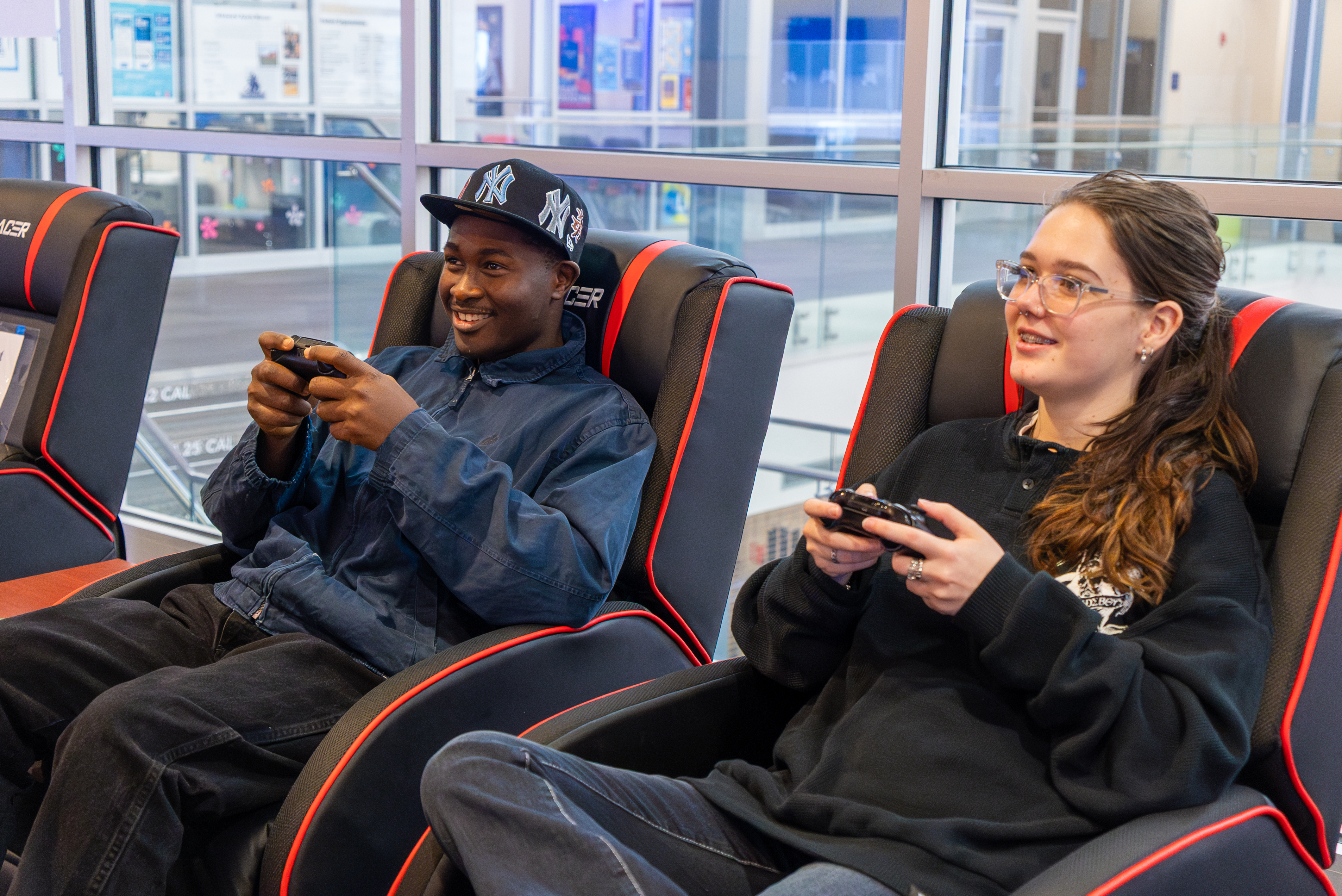 Two students having fun playing video games together.