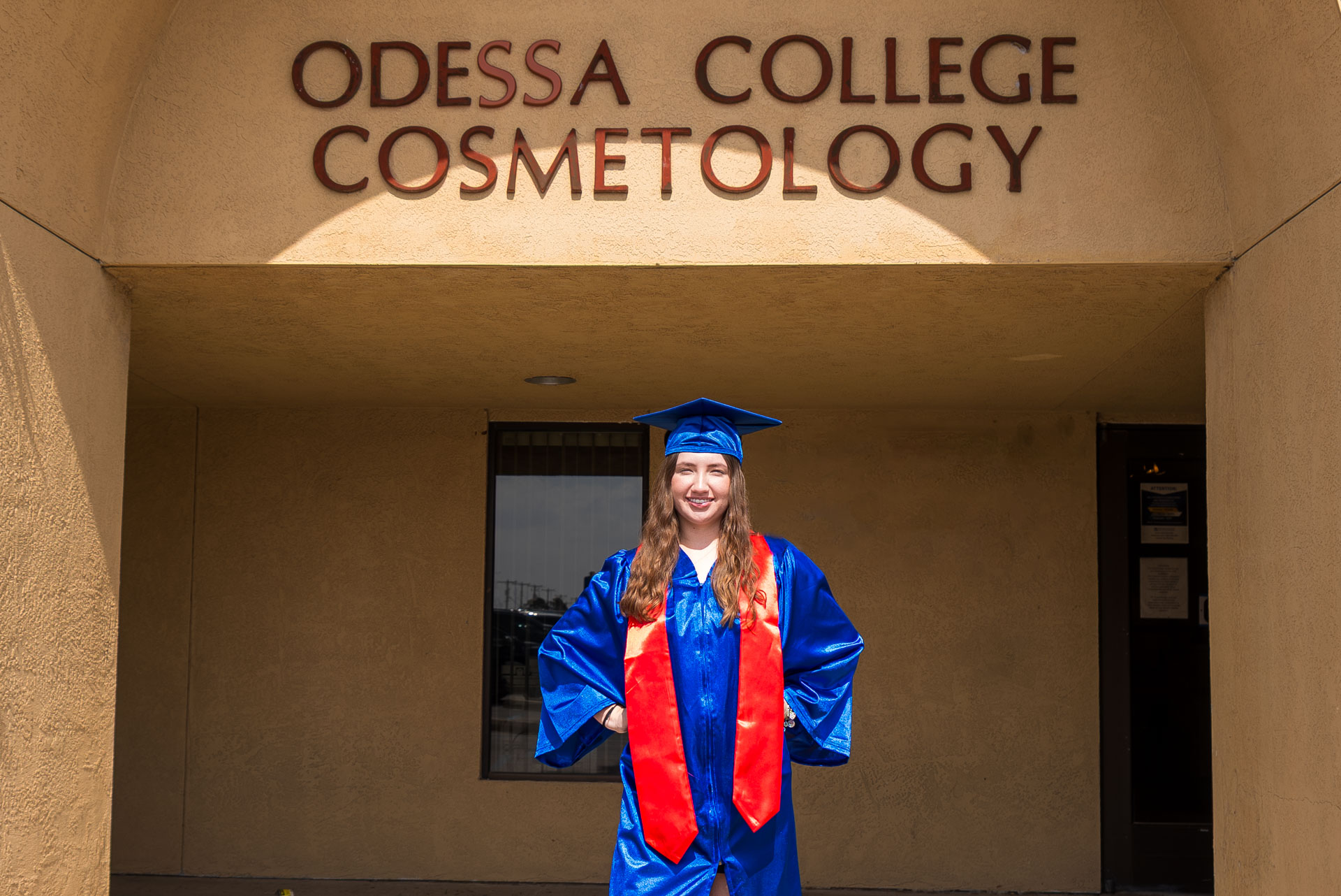 Aubree Lara posing outside the OC Cosmetology building 