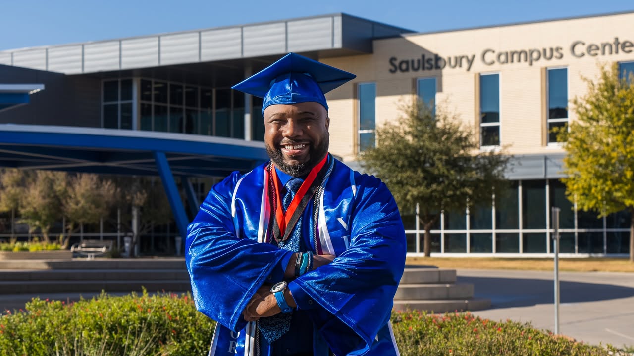 Kory Grant with crossed arms and a big smile
