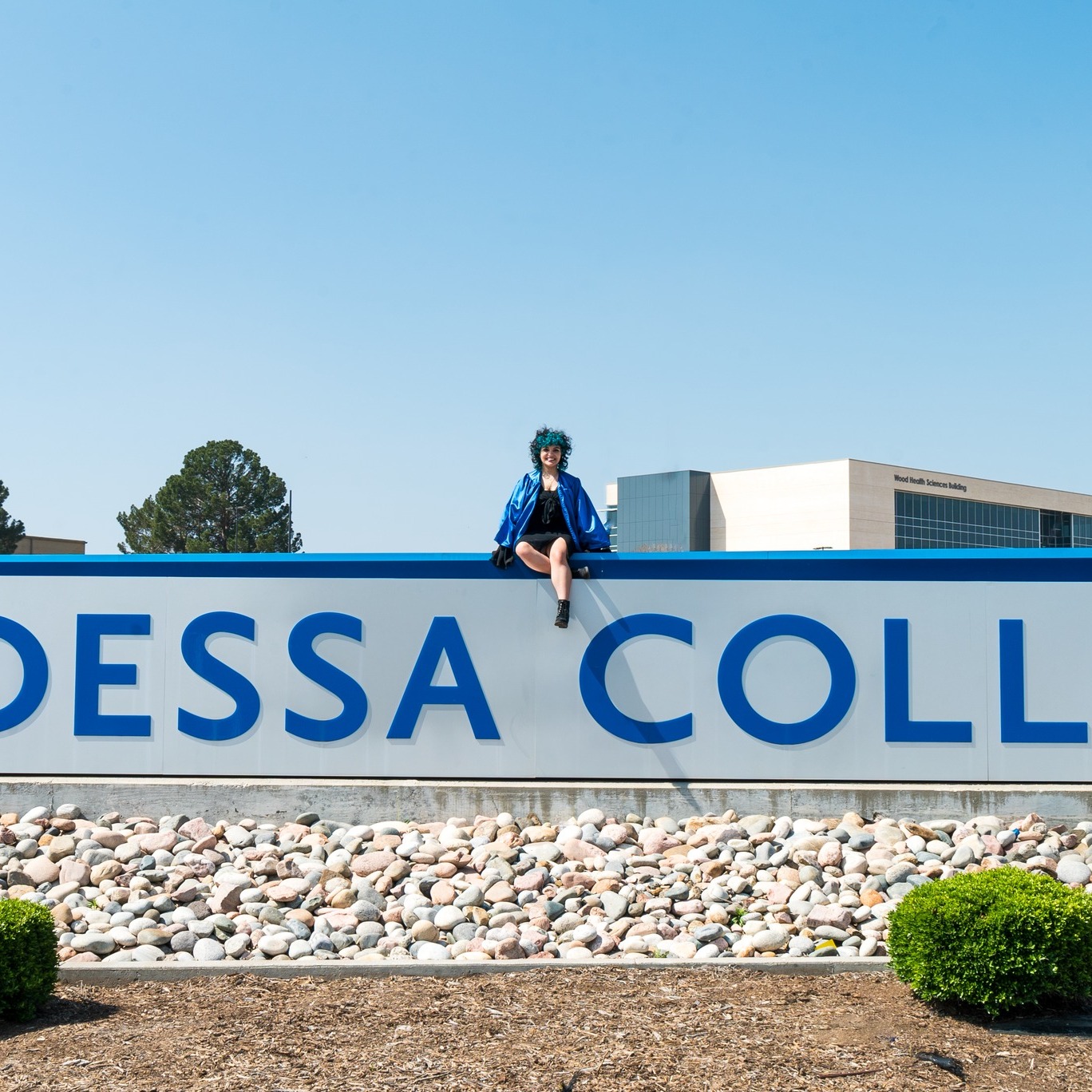 Andy Soto sitting on OC sign