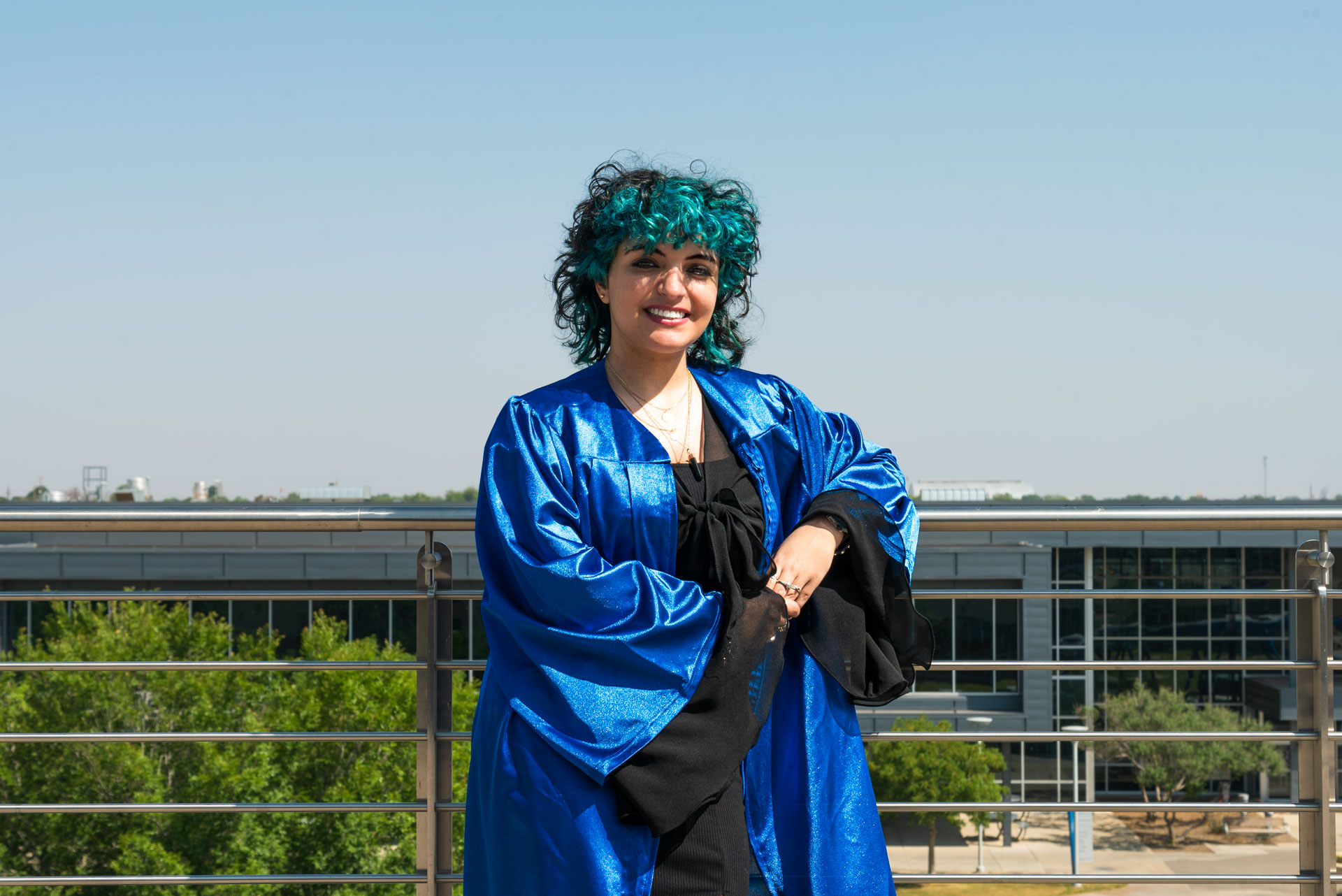 Andy Soto posing by balcony rail