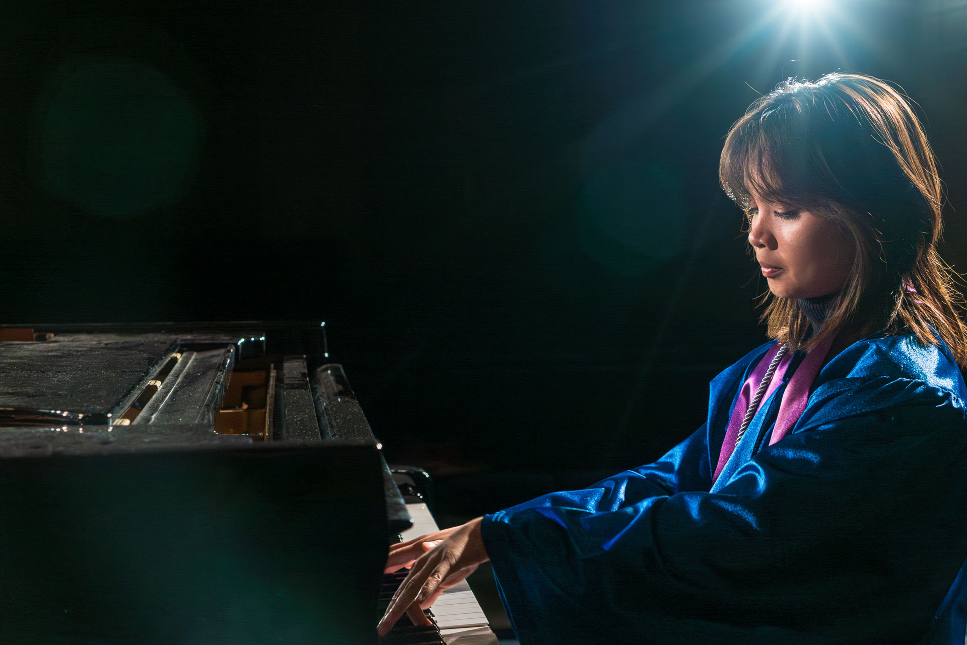 Arabella playing piano in dark room