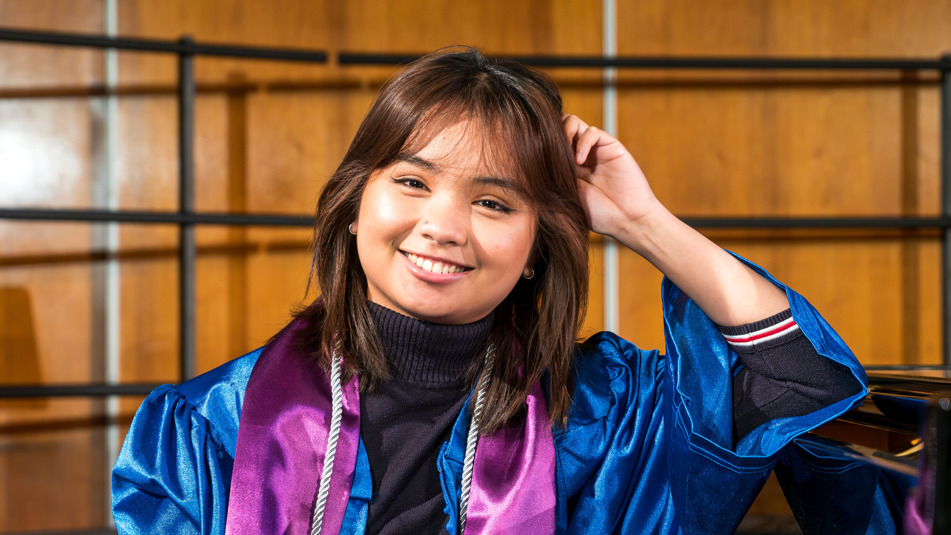 Arabella smiling next to piano