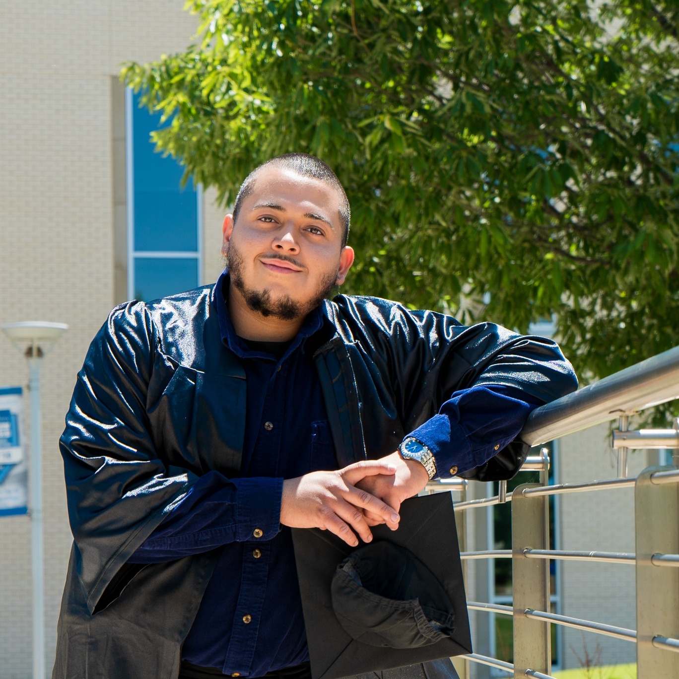 Jonathan leaning against railing and smiling