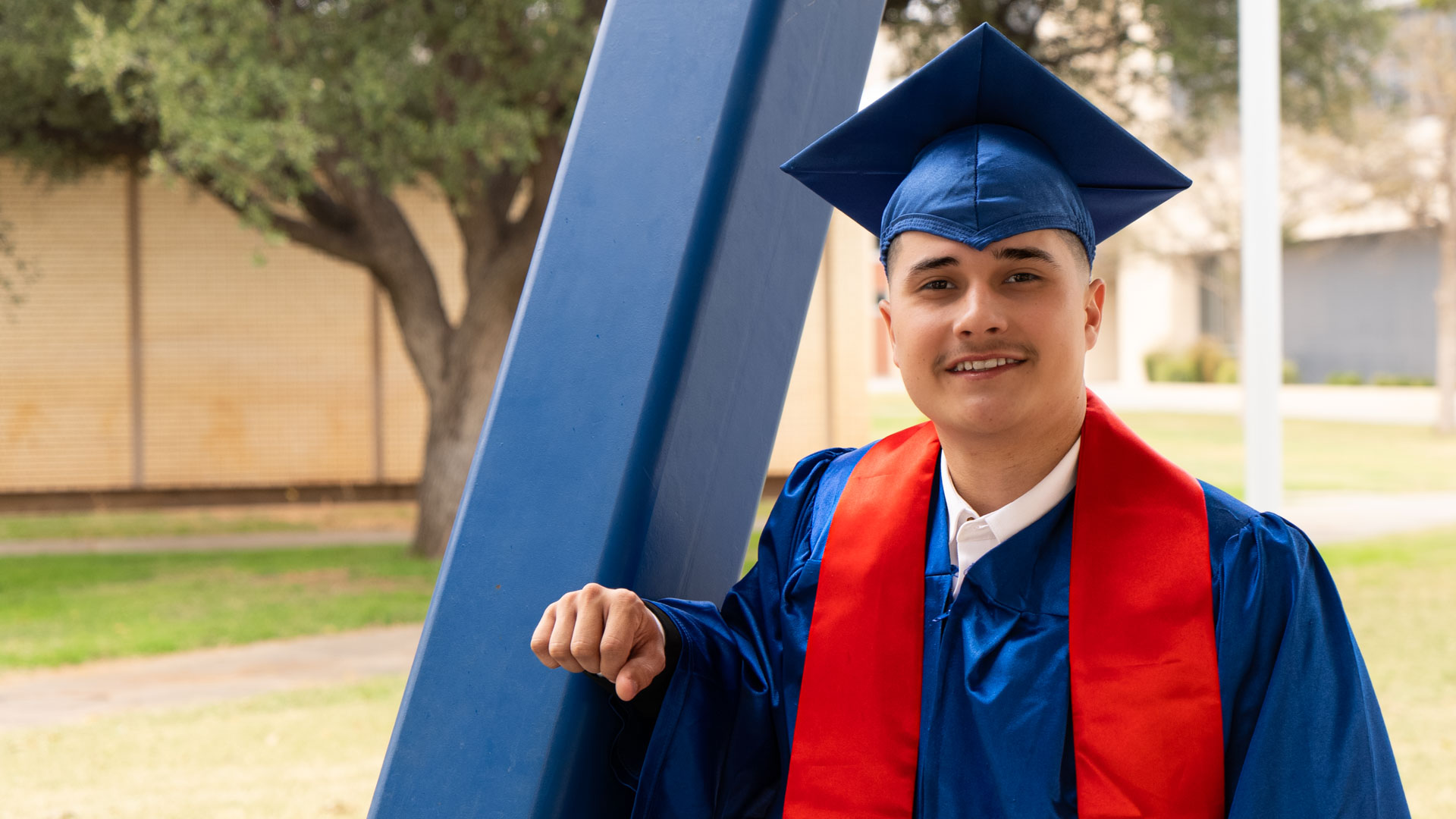 Aldo Cortez posing by amphitheater