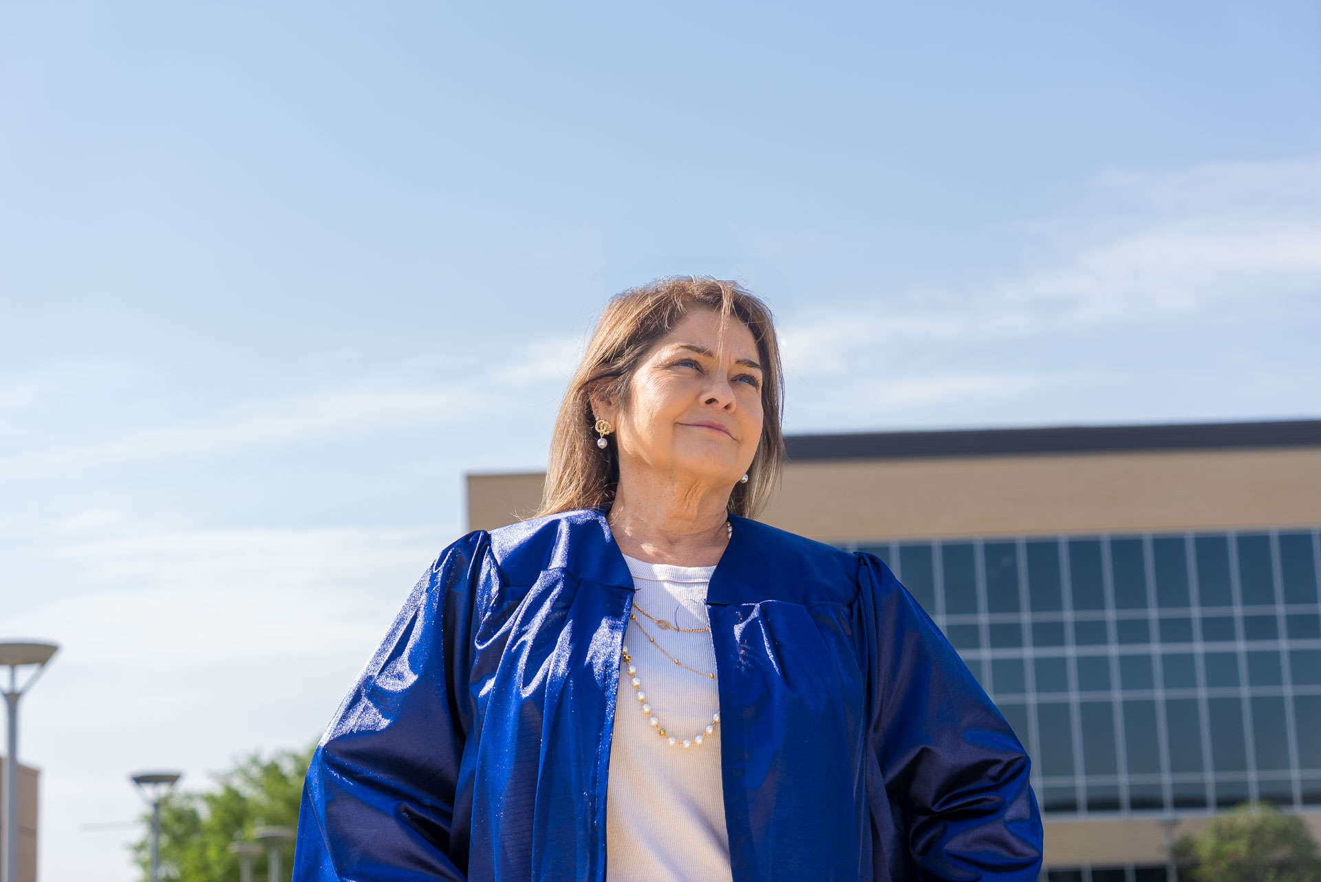 Jeanette Martinez standing with hands on hips and looking up