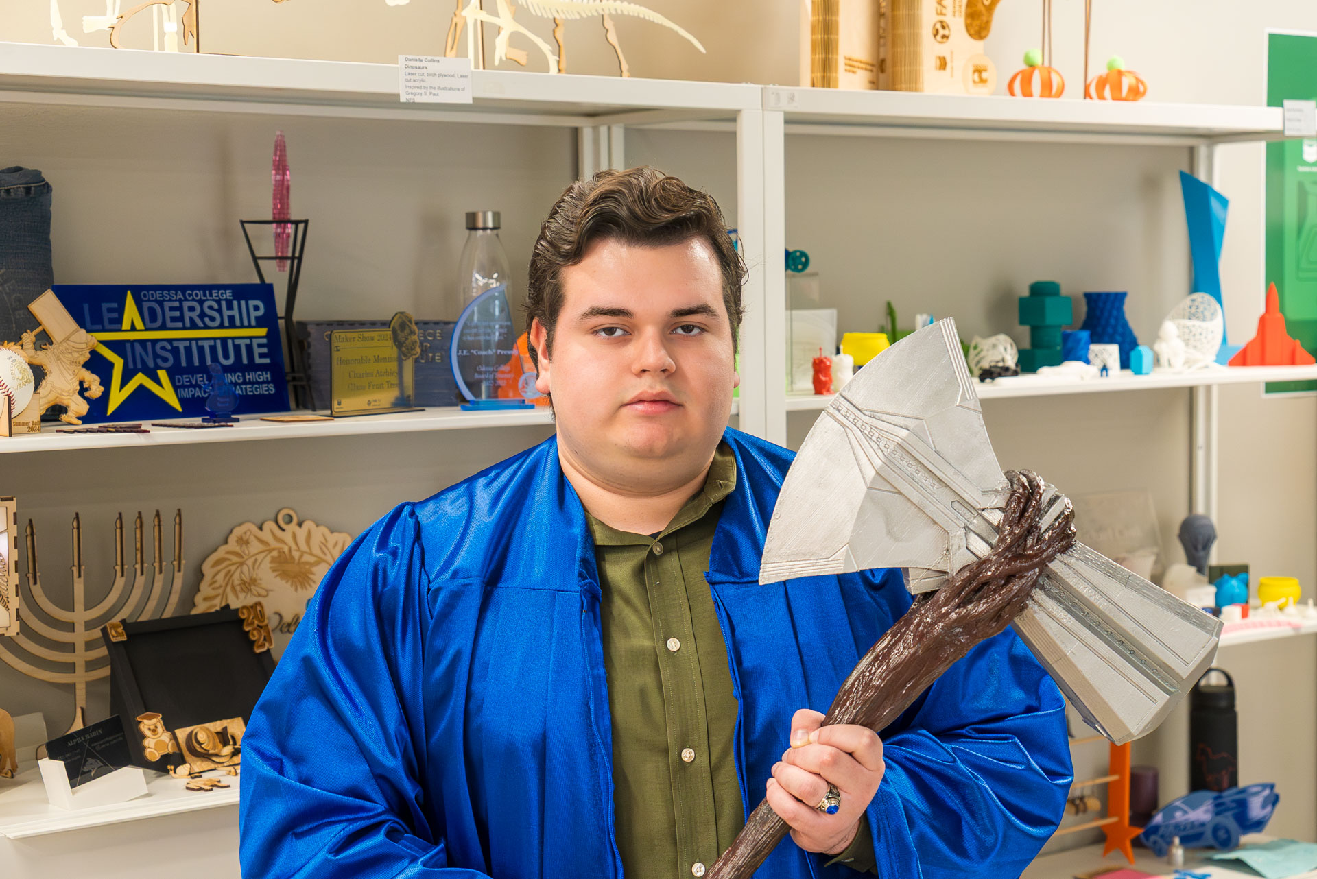 Joel Alvidrez holding a hammer prop