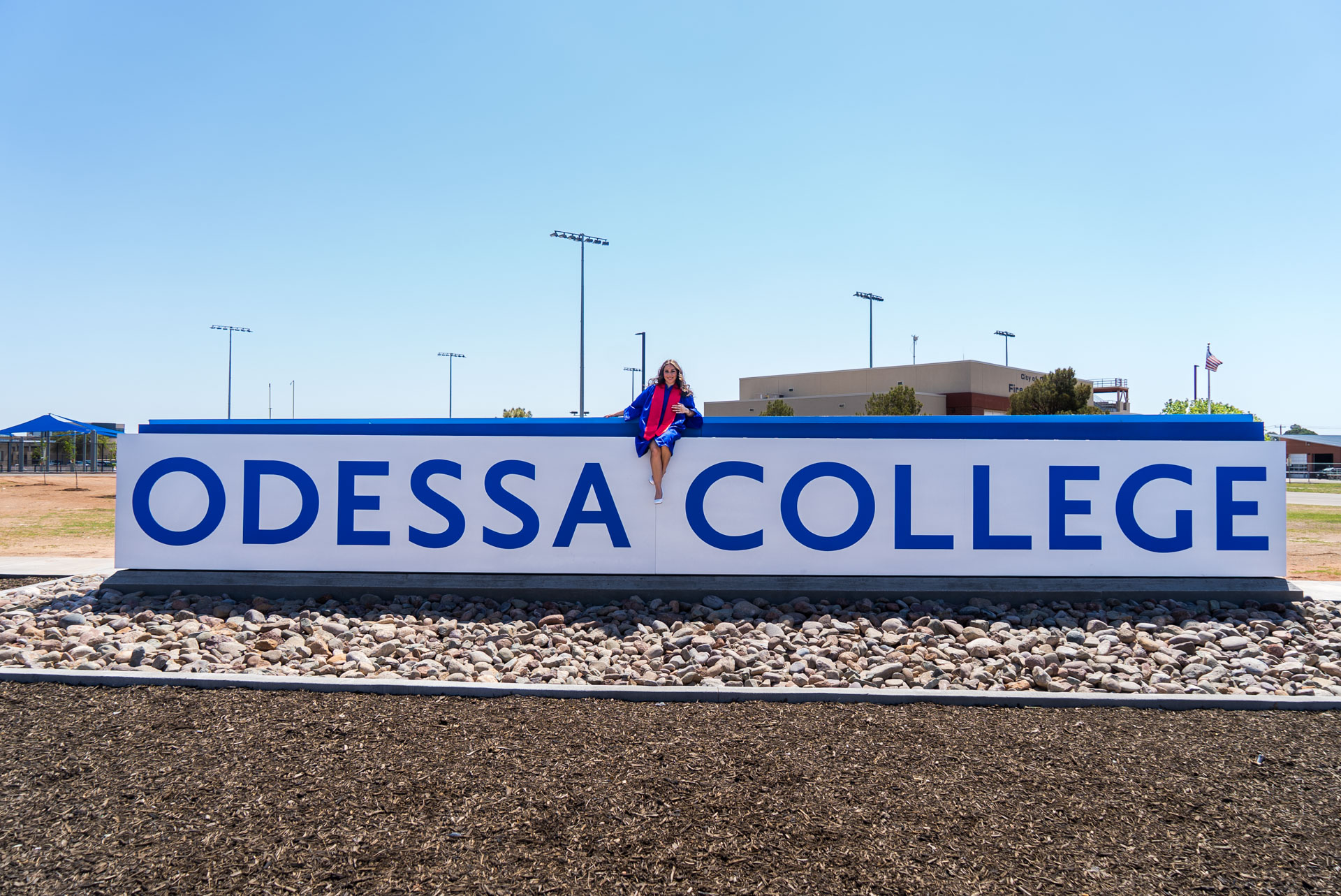 Nevaeh Martinez sitting on top of OC sign