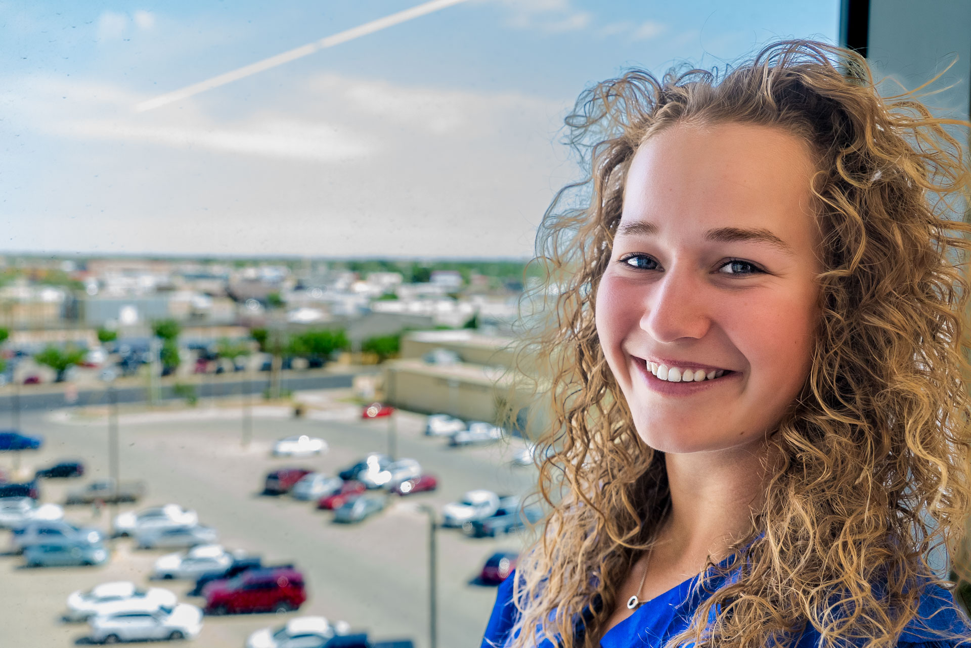 Rens Tellekamp smiling with parking lot behind her in the distance
