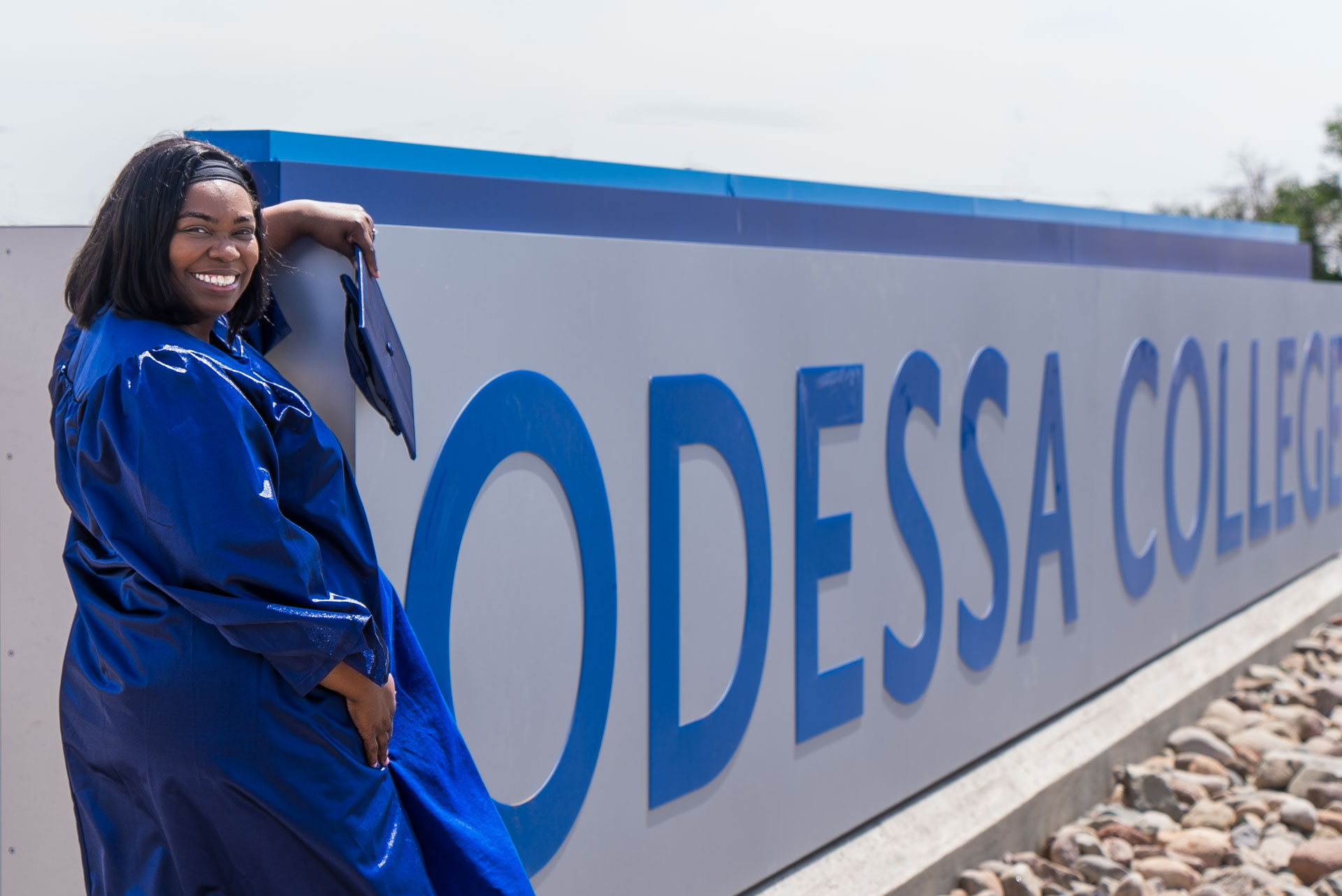 Ruth Watson posing next to OC sign