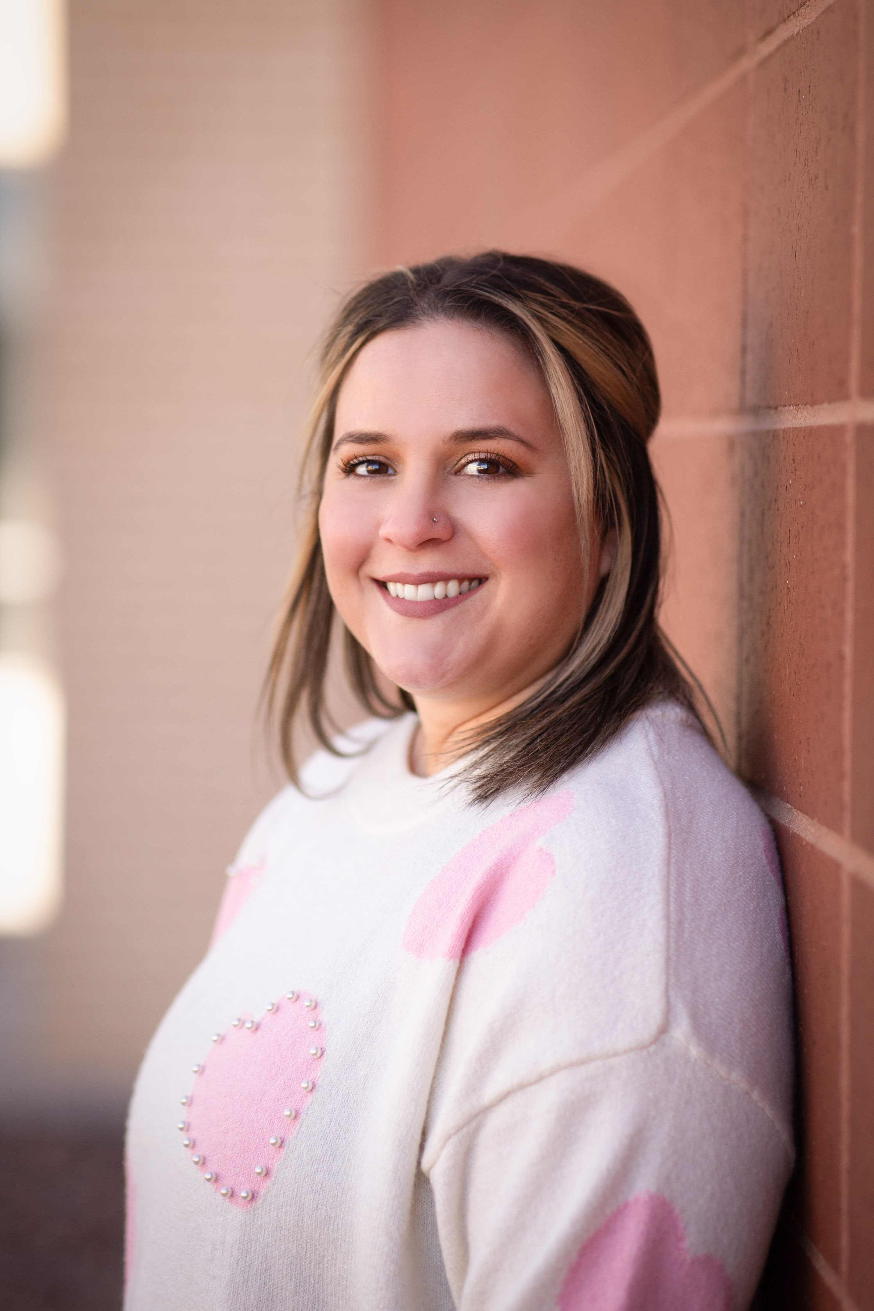  Woman in white sweater with pink hearts
